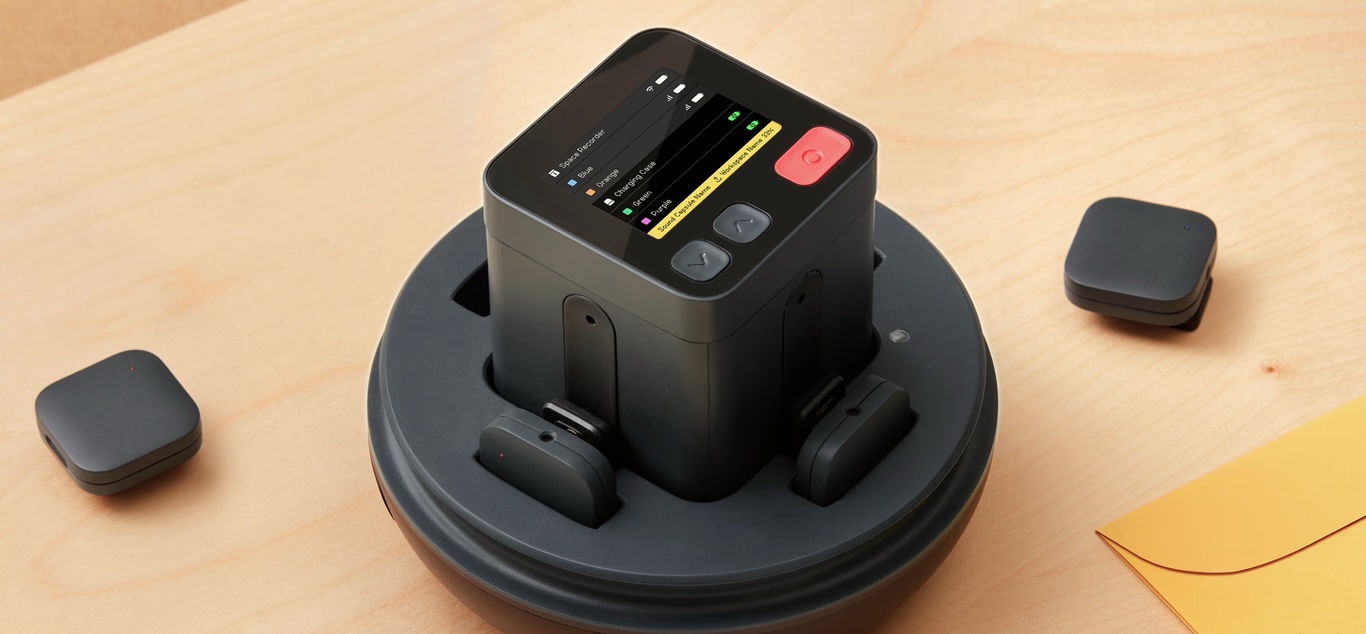Nomono Sound Capsule space recorder docked in its charging base with wireless mics
